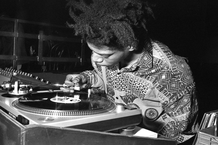 Jean-Michel Basquiat DJing at Area, New York, 1985 (b/w photo)