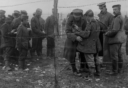 Soldiers Searching Young Prisoners, 1916 (b/w photo)