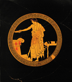 Young man pouring a libation on an altar …