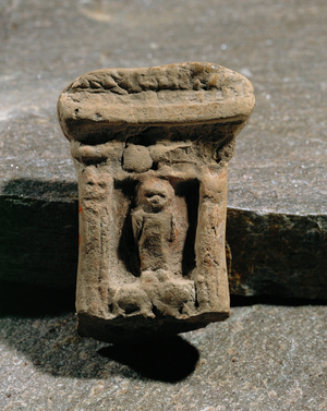 Naos with deity standing on two lions …