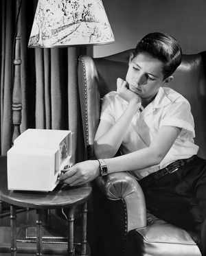 Boy operating radio