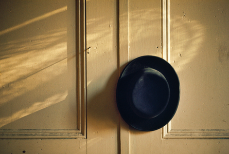 Black hat hangs on a peg on paneled wall in a Yeshiva., 1972 (photo)