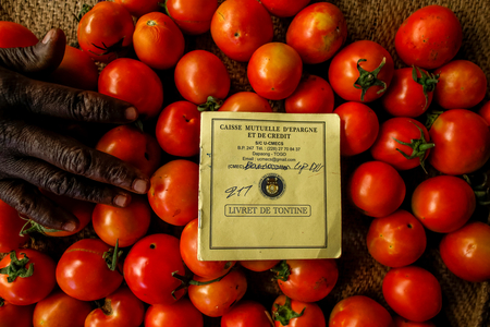 Shopkeeper's microfinance saving book at the market in Dapaong, Togo (photo)