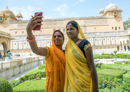 Indian women taking selfie in front of Amer fort and palace, Rajasthan, Amer, India, 2019 (photo)