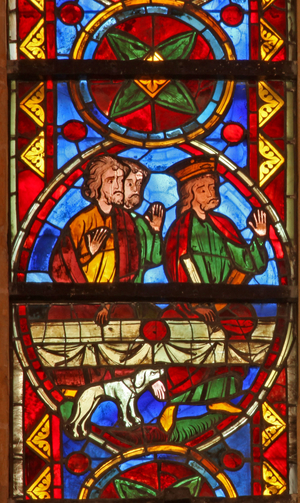 Window w213 depicting a scene from the life of St Thomas: at the banquet a dog brings in the cupbearer's arm (stained glass)