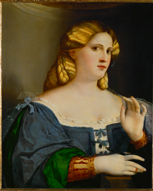 Young woman with fan in a blue dress