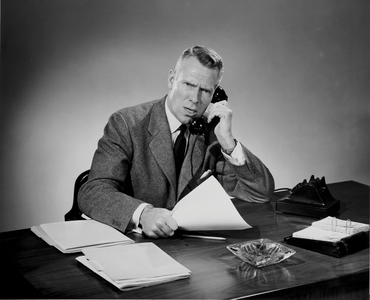 Mature businessman arguing on telephone