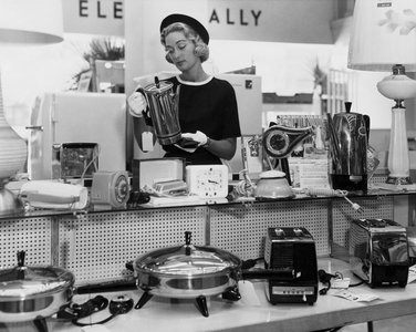 Woman inspecting households items in a store