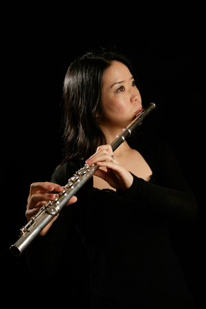 Young woman playing the flute