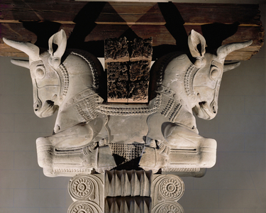 Two bulls' heads. Capital and pillar, grey limestone ...