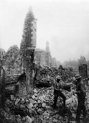 Official photograph taken on the British Western Front showing building hit by bombs and gunfire, 1917-1918 (photograph)