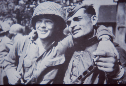 Eastern Front WW2, US and Soviet soldier embrace at Torgau on Elbe at end of war, 27 April 1945 (b/w photo)