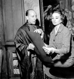 Marquis of Cuevas giving some advice to his friend Viscountess Jacqueline of Ribes for the choice of dances she will present, Paris, October 26, 1957 (b/w photo)