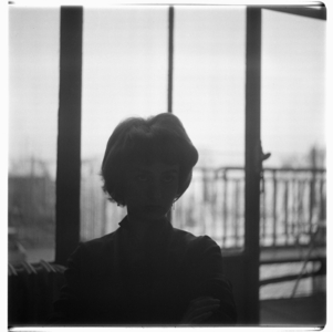 Pegeen Vail Guggenheim, portrait of Pegeen Guggenheim, daughter of Peggy Guggenheim, wife of situationist painter Ralph Rumney, step-daughter of Max Ernst, in her home in Paris, France mid 1950's (b/w photo)