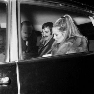 Jean Paul Belmondo and Ursula Andress signing autographs on their way to a charity sale of children's drawings on 14 December 1966 (photo)