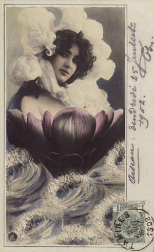 Beautiful woman emerging from a flower emerging from the sea (tinted photo)