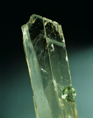 Spodumene crystal and cut stone