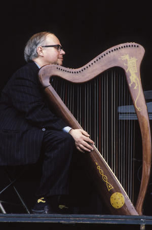 Member of The Dubliners with celtic harp, performing at Fleadh 1996. Irish folk music. Rock.