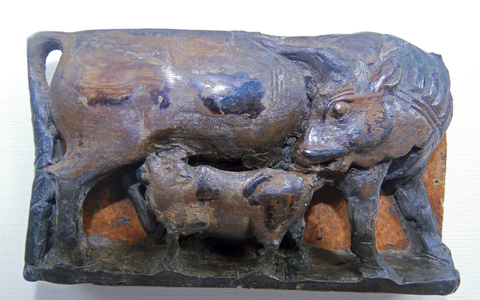 Ivory depicting a cow suckling its calf