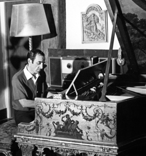 Charles Aznavour playing the piano, 1965 (photo)