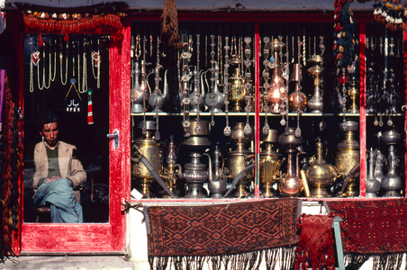 Shopkeeper at door of shop selling metalwork items including coffeepots, teapots, sam…, 1968 (photo)