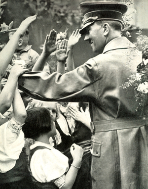 Adolf Hitler greets crowd during a visit to a German town, c1938.