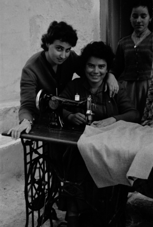 Travel to Greece - young women on a sewing machine. Women with a sewing machine. Image date circa 1954. Photo Erich Andres