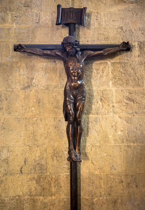 Old Italian crucifix, made of wood, with Jesus Christ symbol of resurrection and salvation, 2020 (photo)