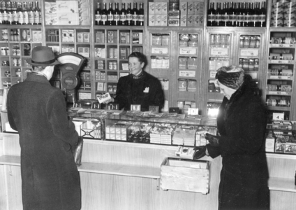 Customer and a saleswoman in a grocery store, 1942 (b/w photo)