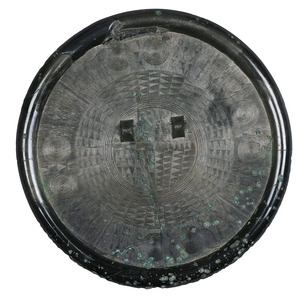 Korea: Bronze mirror with intricate linear designs and two raised knobs, late bronze- early iron age, c. 300 BCE