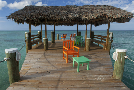 Wooden pier at Hotel Compass Point Resort at Love beach Nassau, Bahamas, Caribbean. Brightly Colored Cottages At Compass Point Beach Club, 2019 (photo)