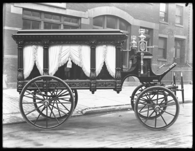 Horse-drawn hearse belonging to F.S. York, parked on W. 145th Street (or E. 145th Street), New York City, December 1, 1914 (b/w photo)