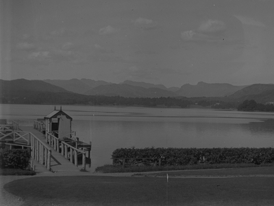 View of jetty and calm Windermere with fells in distance, 1930s-60s (b/w photo)