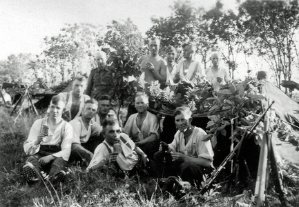 Twelve young soldiers of the Wehrmacht with a tent in the forest, France, 1944 (b/w photo)