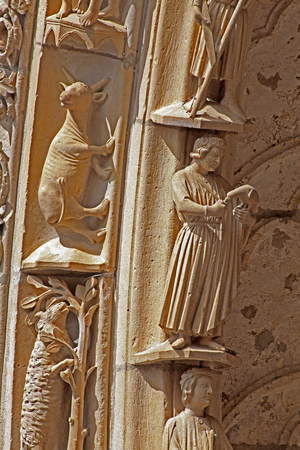 Chartres, Cathedral: North portal right door outer archivolt: the months & the signs of the zodiac: May (with falcon) and Taurus (photo)