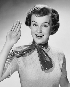 Portrait of a young woman waving