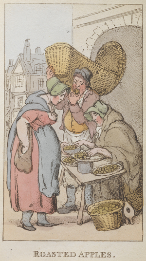 'Roasted apples'. A steet trader selling apples from a stall.