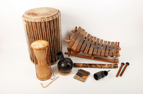 A collection of African musical instrument. Back row left to right - Doum Doum drum, African Marimba or Balafon, Front row - Tlking drum, Urdu or Udu drum, Kalimba or Mbira, Valiha or Bamboo zither, a Gankeke Bell, sticks for the Marimba.