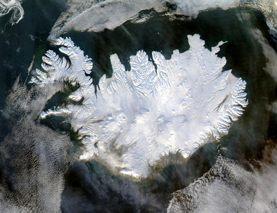 Satellite image of Iceland on 28 January 2004 showing it covered in a blanket of snow and ice which is obscuring the permanent glaciers and icecaps that exist year-round. Credit NASA. Science Winter