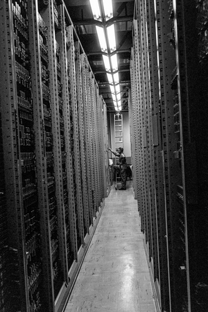 Technician Bob Blore checks telephone switching at PacTel central station, Bellingham WA, 1960 (photo)