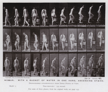 The Human Figure in Motion: Woman, with a bucket of water in one hand, ascending stairs (b/w photo)