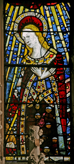 The East window (Ew) depicting the Virgin Mary (composite figure) - with "jewels" of inset glass (stained glass)