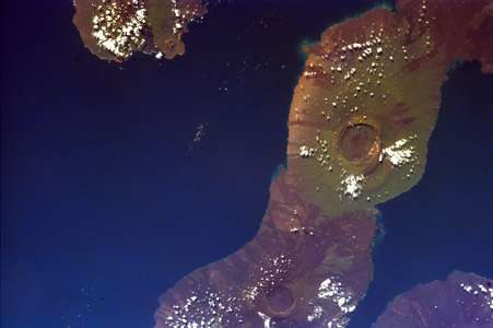 This image of the Galapagos Islands captures two large shield volcanoes on Isla Isabella, The northern volcano is Darwin and the southern, Alcedo. Isla Fernandina and Isla San Salvador are just visible on either side of Isla Isabella.