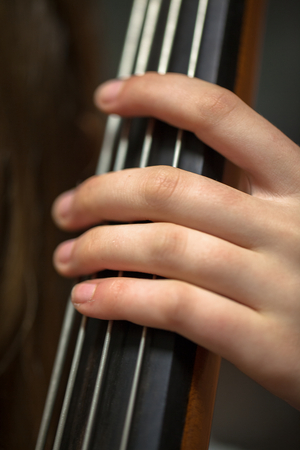 Cellist's hand on the neck of his instrument, 2014 (photo)