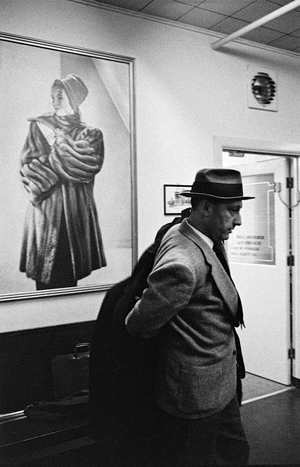Fur broker putting on his overcoat after inspecting furs at auction, 1963 (photo)