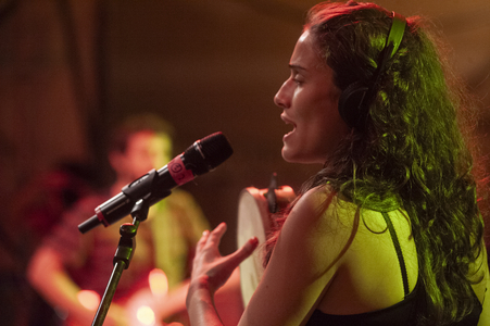 Mercedes Peòn's band singer performing at Carpino Folk Festival, Puglia, Italy, 2014 (photo)