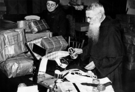 Priest preparing parcel for prisoners of war, 1941, France