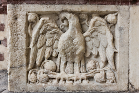 Genoa, Duomo (St Lawrence Cathedral), West side, the façade, the left doorway: "Eagle with spread wings", figured panel of the base decoration