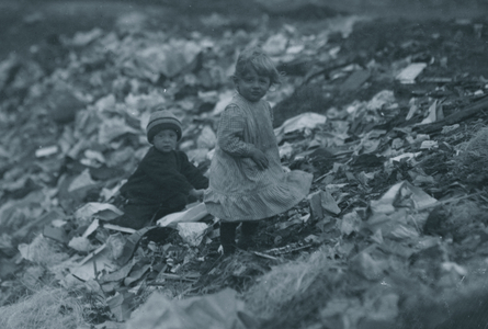 Two children going through the "Dumps." Location 1912 (photo)