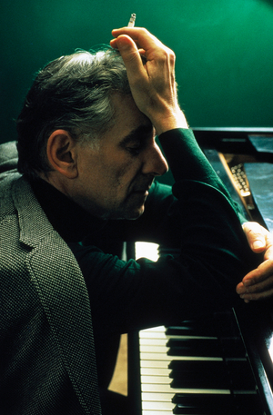 Leonard Bernstein resting against